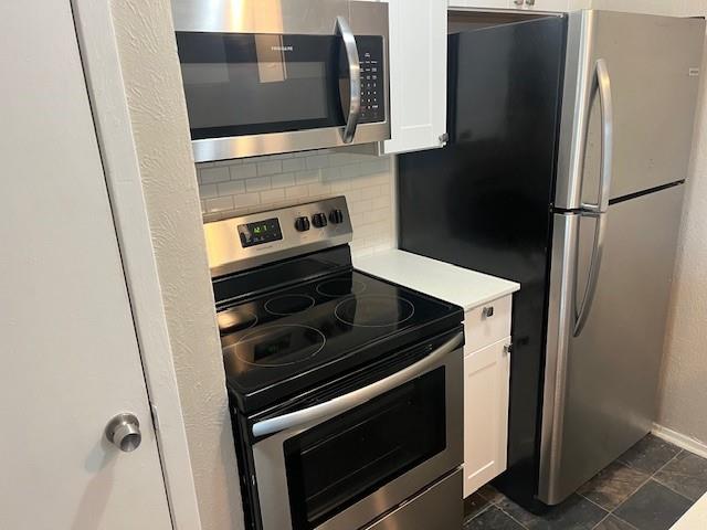 2821 Reagan Street, Unit 202 Dallas, TX 75219 - Photo 5 of 13 a kitchen with granite countertop a refrigerator stove and microwave