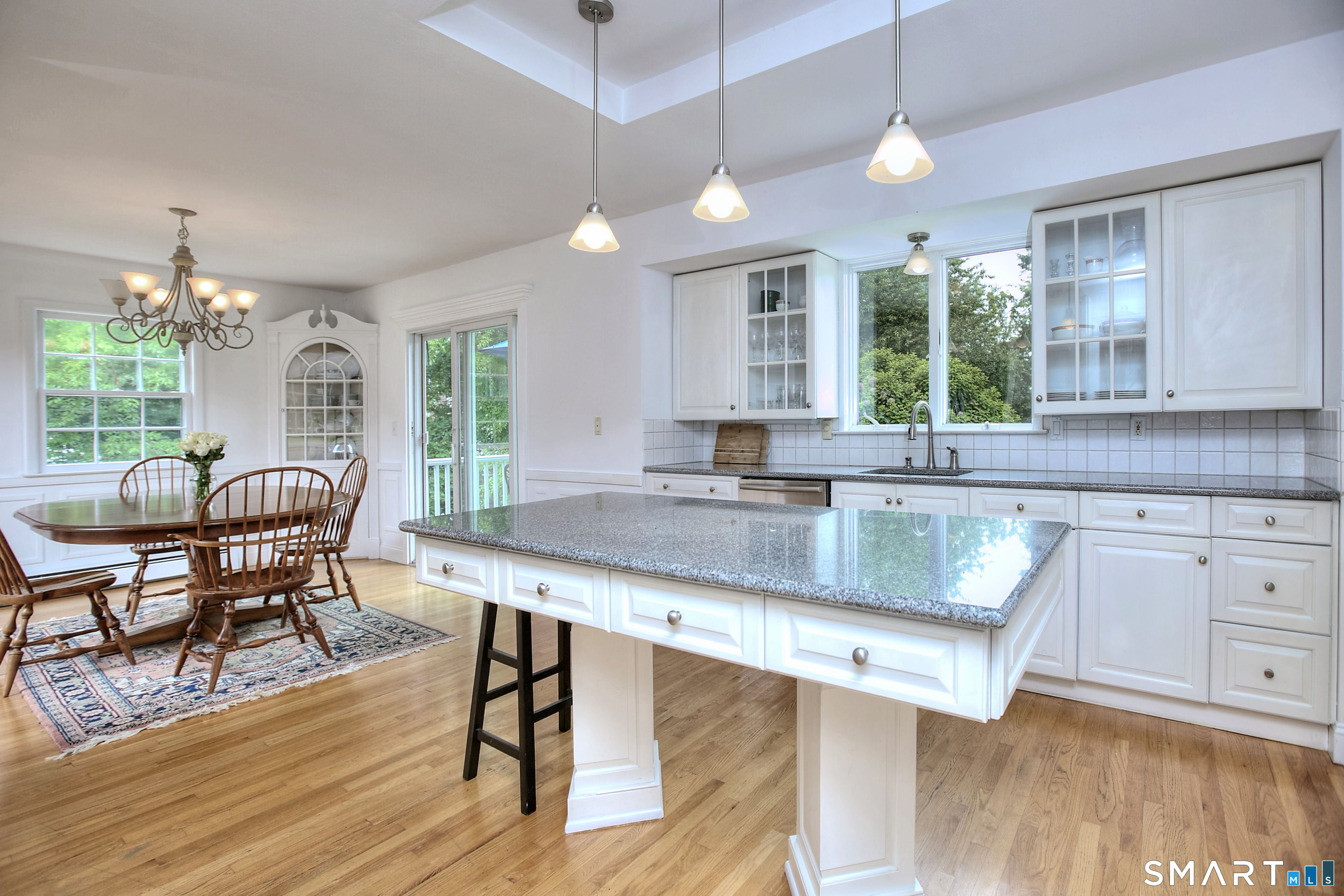 324 Ridge Road Orange, CT 06477 - Photo 12 of 38 a kitchen with stainless steel appliances granite countertop wooden floors a stove a sink and a window