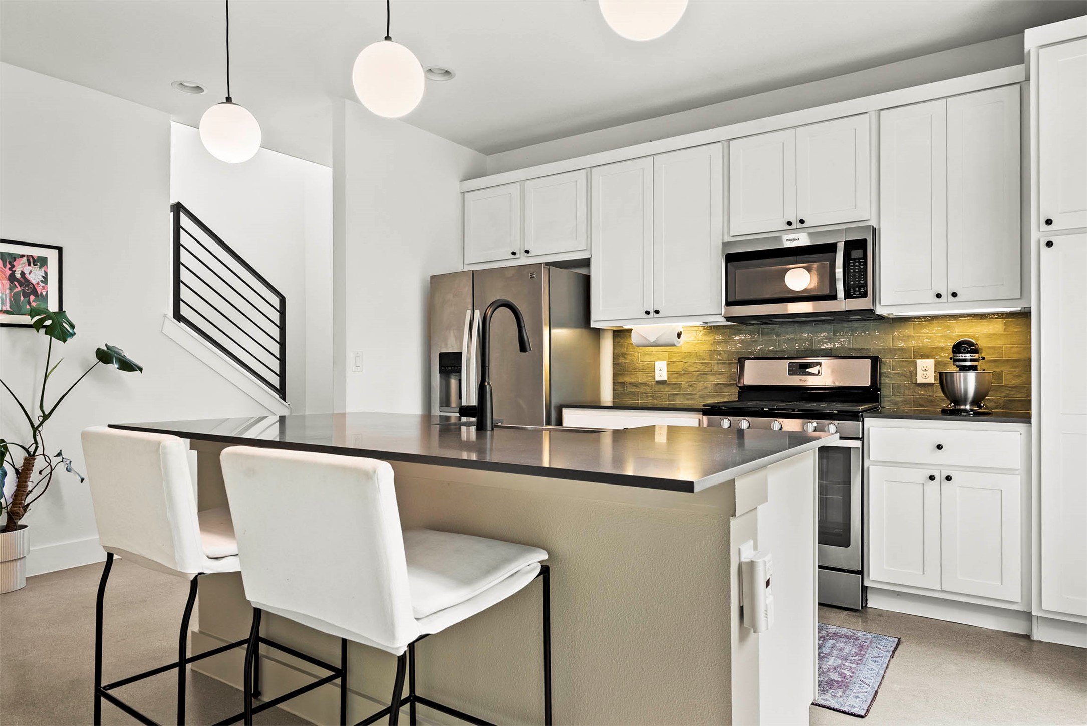 1213 Eleanor Street, Unit B Austin, TX 78721 - Photo 14 of 35 The kitchen features shaker-style cabinetry and quartz countertops for a look that is both timeless and trendy