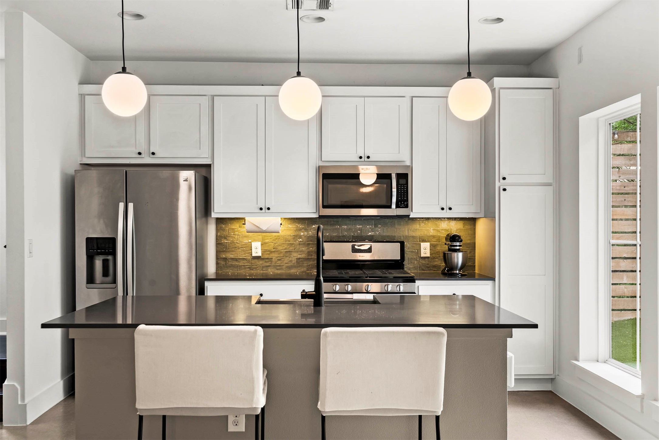 1213 Eleanor Street, Unit B Austin, TX 78721 - Photo 15 of 35 Under-cabinet lighting brightens up the workspace, highlighting the detailed tile backsplash