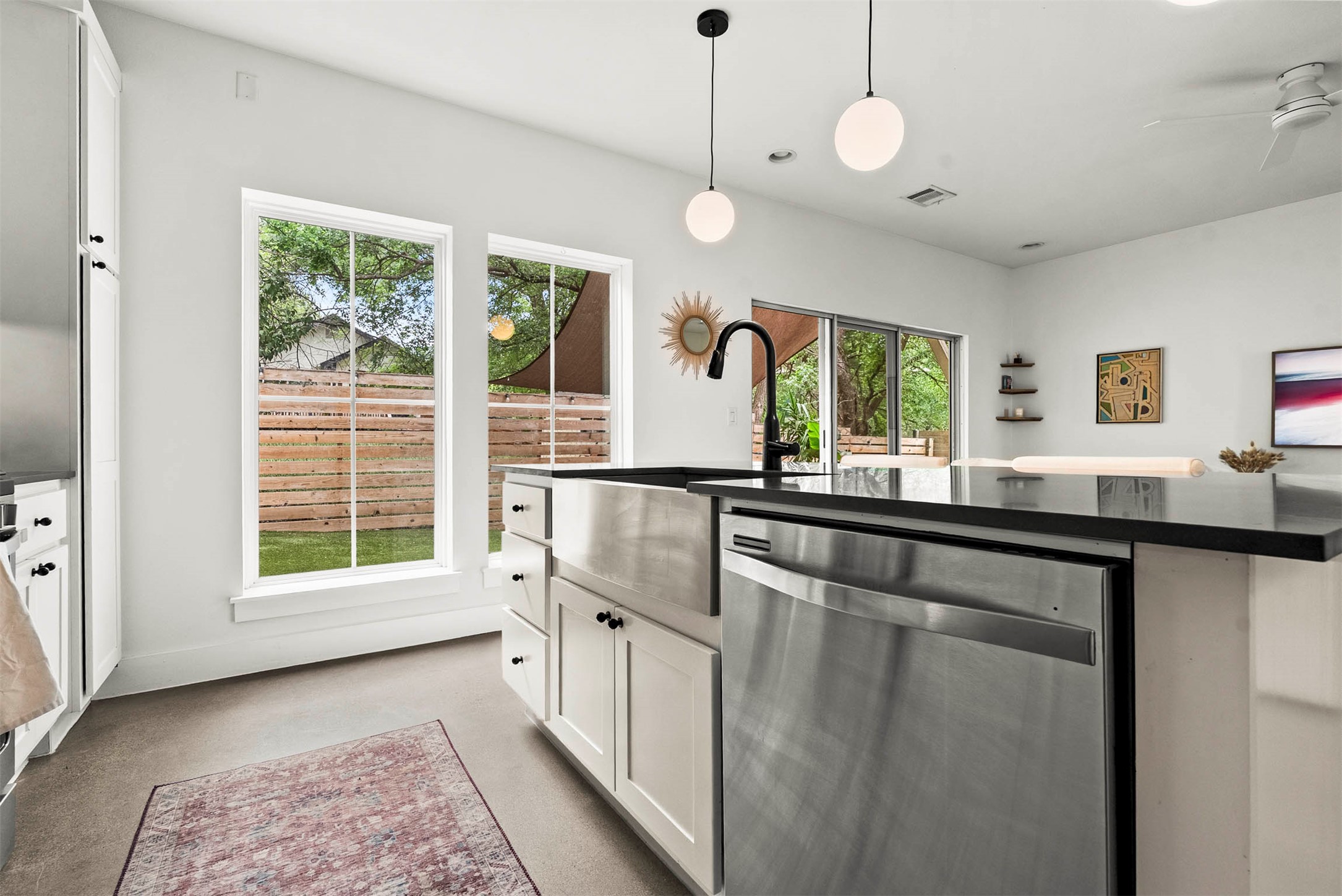 1213 Eleanor Street, Unit B Austin, TX 78721 - Photo 18 of 35 The open kitchen design allows you to prep dinner while still looking out through the glass doors into the yard