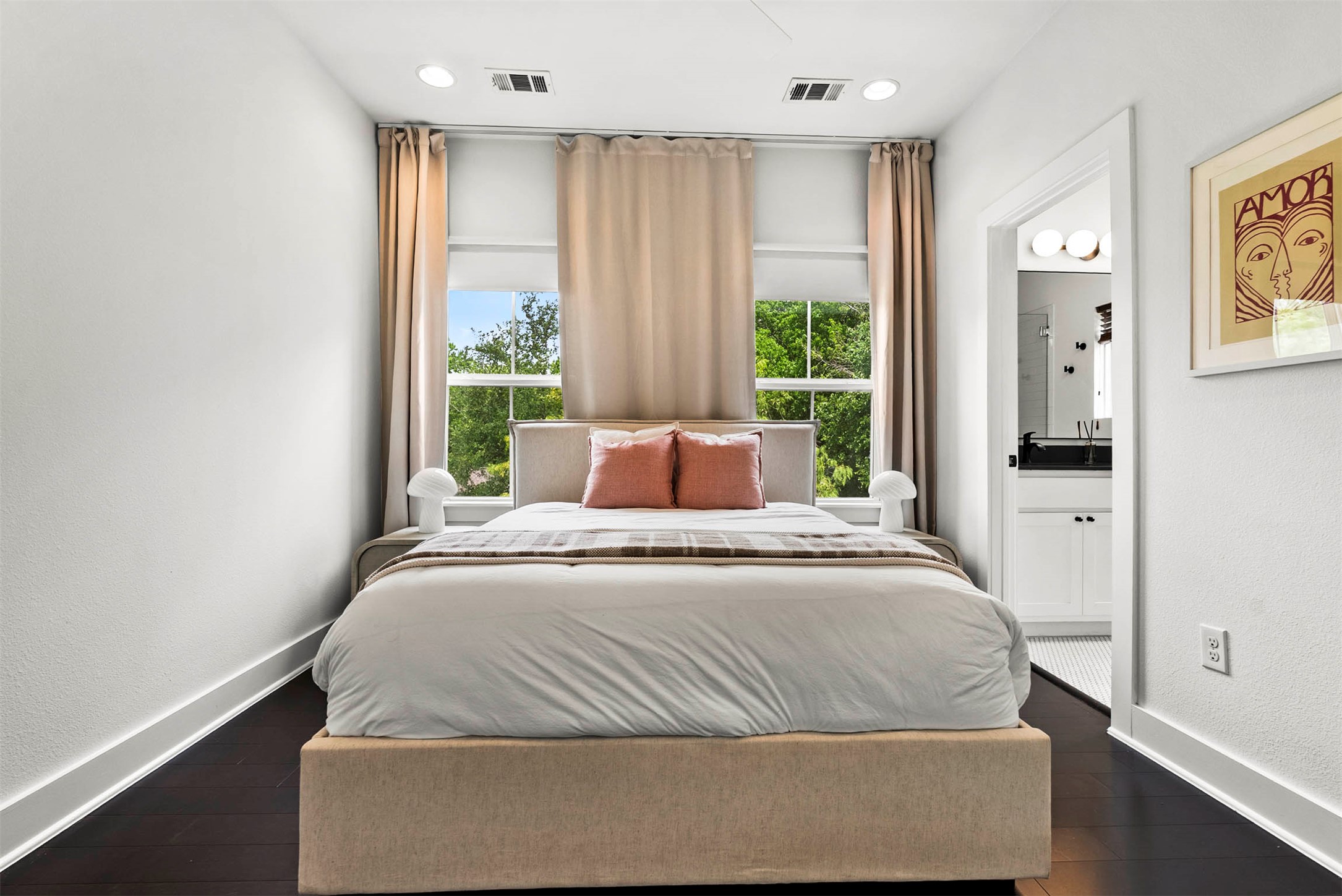 1213 Eleanor Street, Unit B Austin, TX 78721 - Photo 21 of 35 The primary bedroom is a quiet, light-filled space with beautiful wood floors and plenty of room to relax