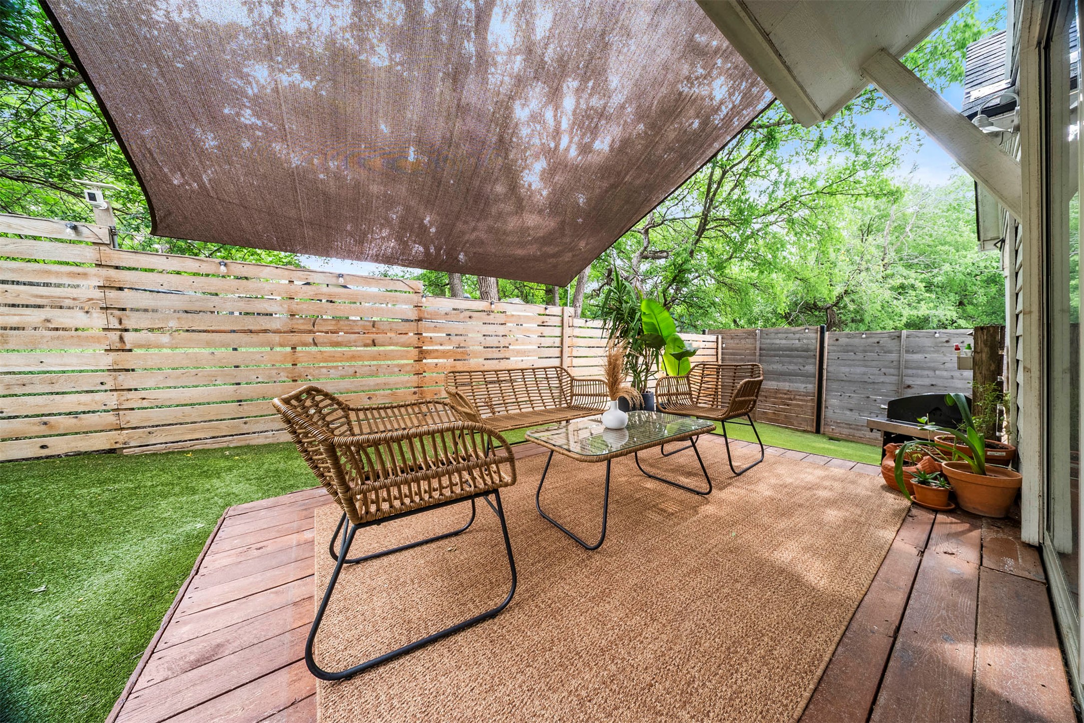 1213 Eleanor Street, Unit B Austin, TX 78721 - Photo 28 of 35 The wood deck is a natural extension of the living room, offering a great spot for outdoor dining or morning yoga