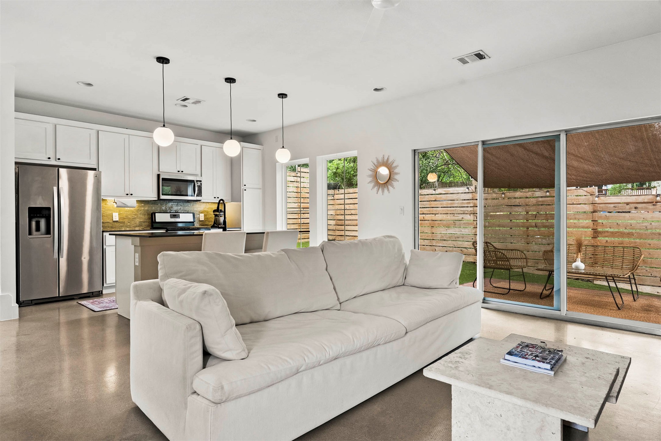 1213 Eleanor Street, Unit B Austin, TX 78721 - Photo 9 of 35 Transitioning from the sofa to the backyard is seamless, making this the ultimate setup for hosting friends