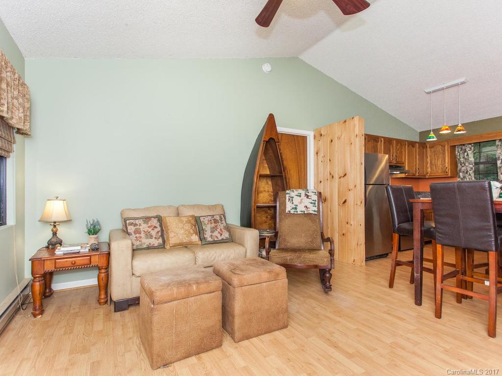 99 Apgar Road Candler, NC 28715 - Photo 2 of 20 a bed room with a bed and a chair