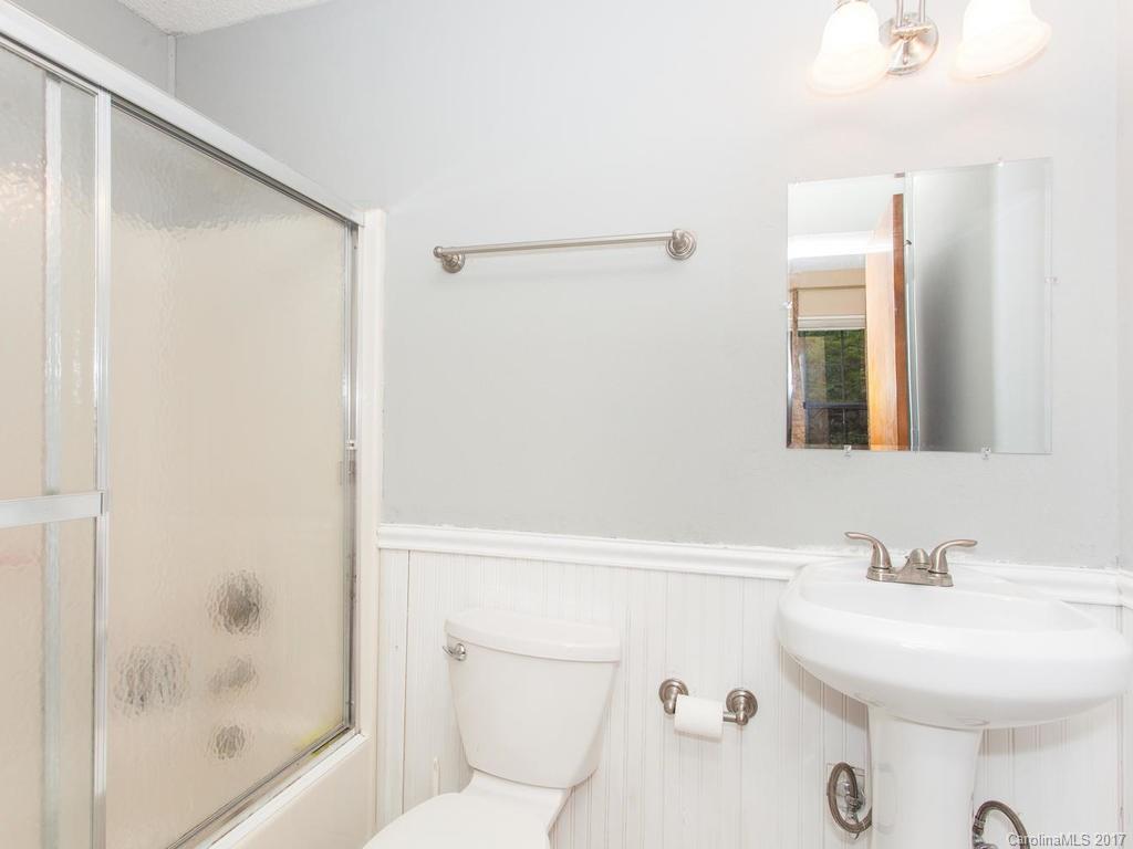 99 Apgar Road Candler, NC 28715 - Photo 11 of 20 a bathroom with a sink a toilet and shower