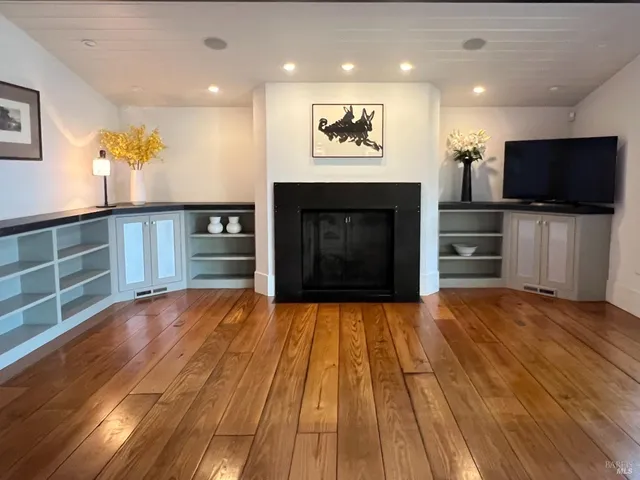 a kitchen with stainless steel appliances granite countertop table chairs stove and refrigerator