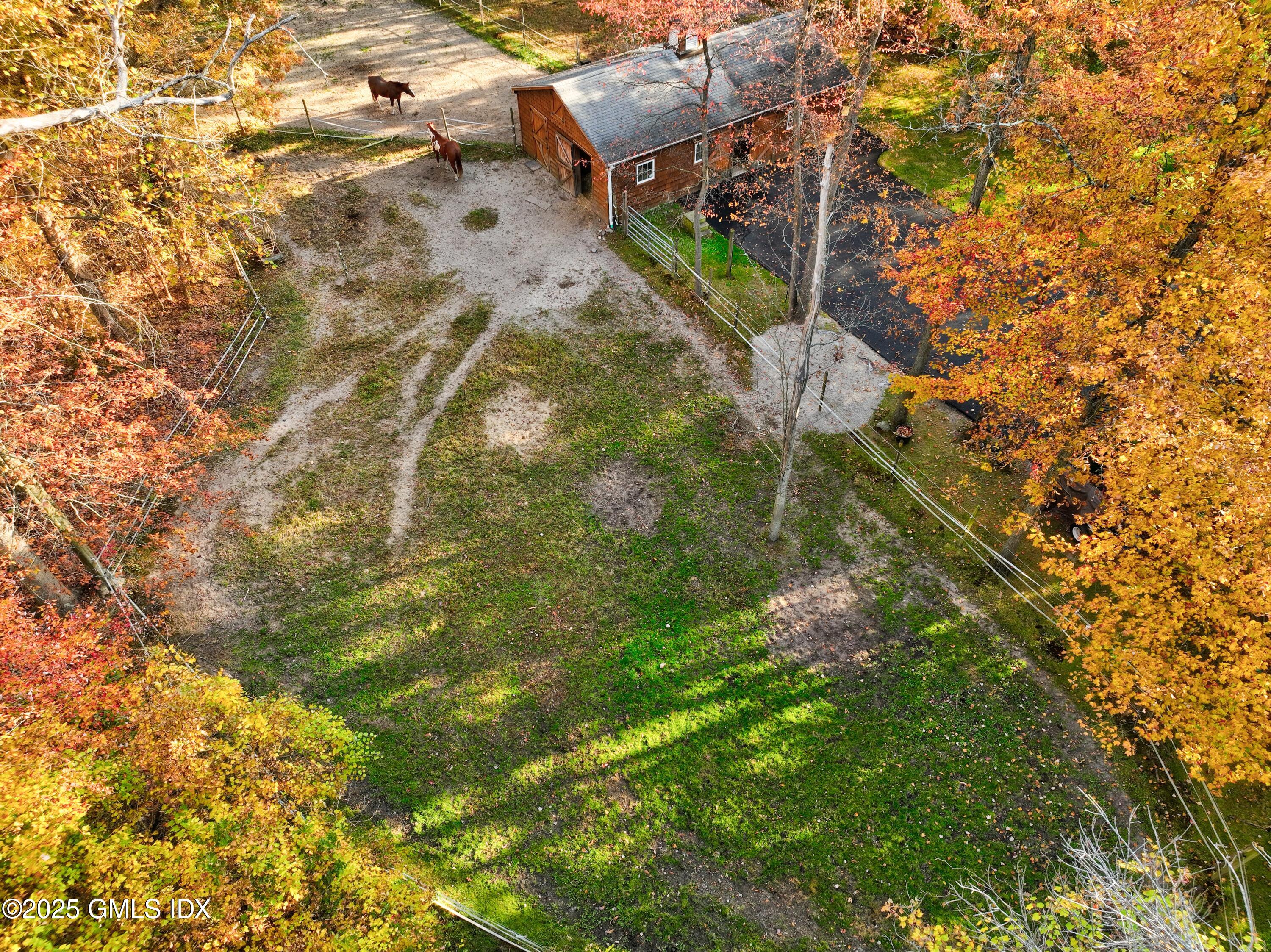 38 Bedford Road Greenwich, CT 06831 - Photo 29 of 32 a backyard of a building with lots of trees