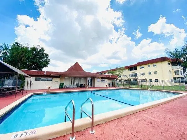 a view of a patio with swimming pool table and chairs