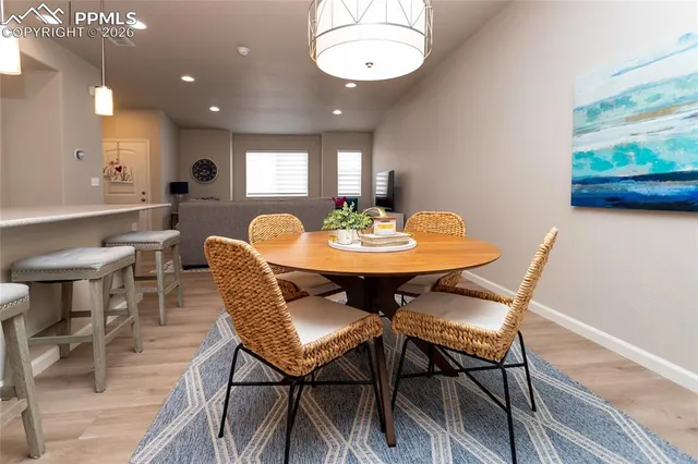 a view of a dining room with furniture and wooden floor