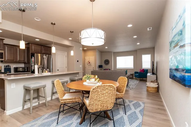 a view of a dining room with furniture and wooden floor