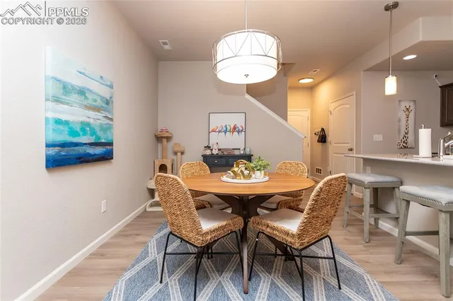 a view of a dining room with furniture and wooden floor