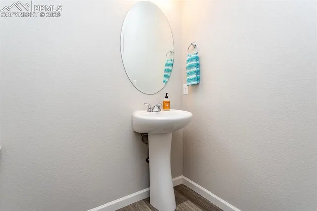 a bathroom with a sink a mirror and toilet