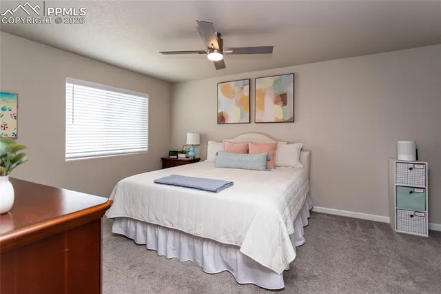 a bedroom with a bed a desk and chair