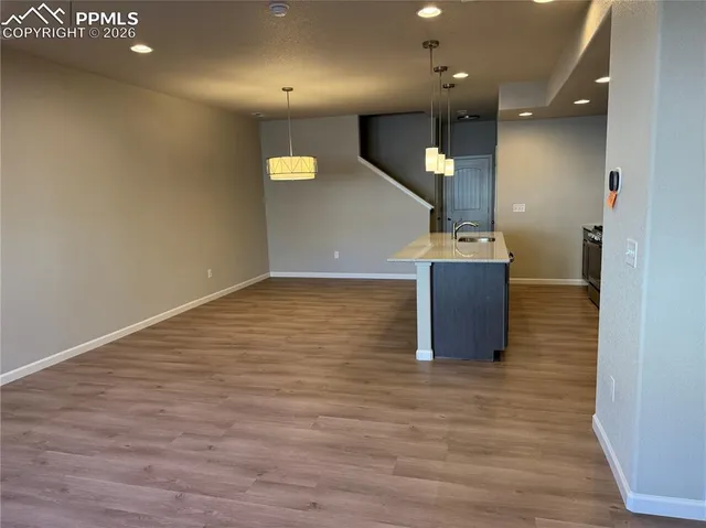 an empty room with wooden floor