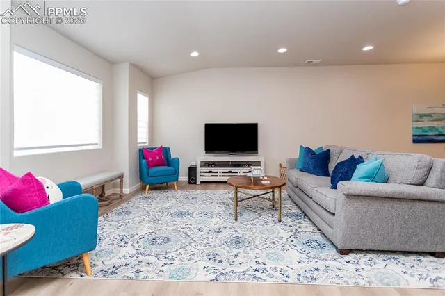 a living room with furniture and a flat screen tv