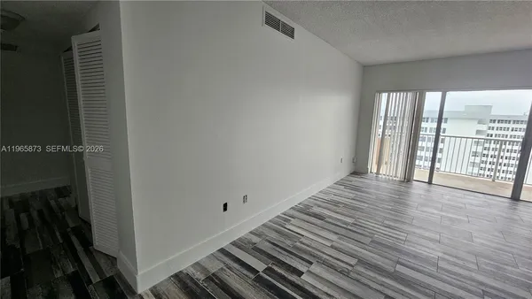 a view of a room with wooden floor