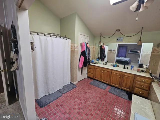 a bed room with a bed and a flat tv screen