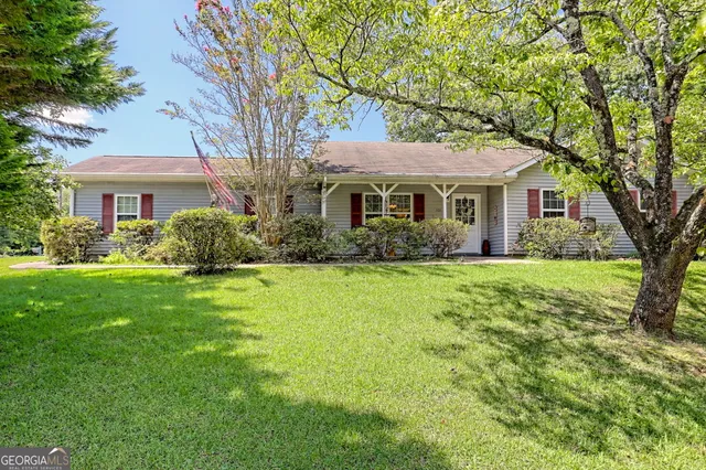 a front view of house with yard and green space