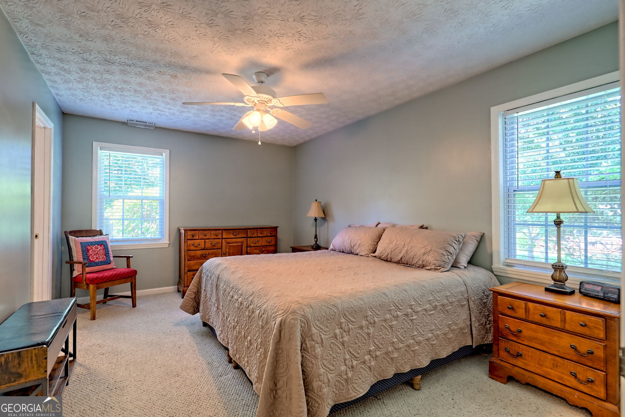 101 Long Street Demorest, GA 30535 - Photo 17 of 61 a bedroom with a bed and a chandelier