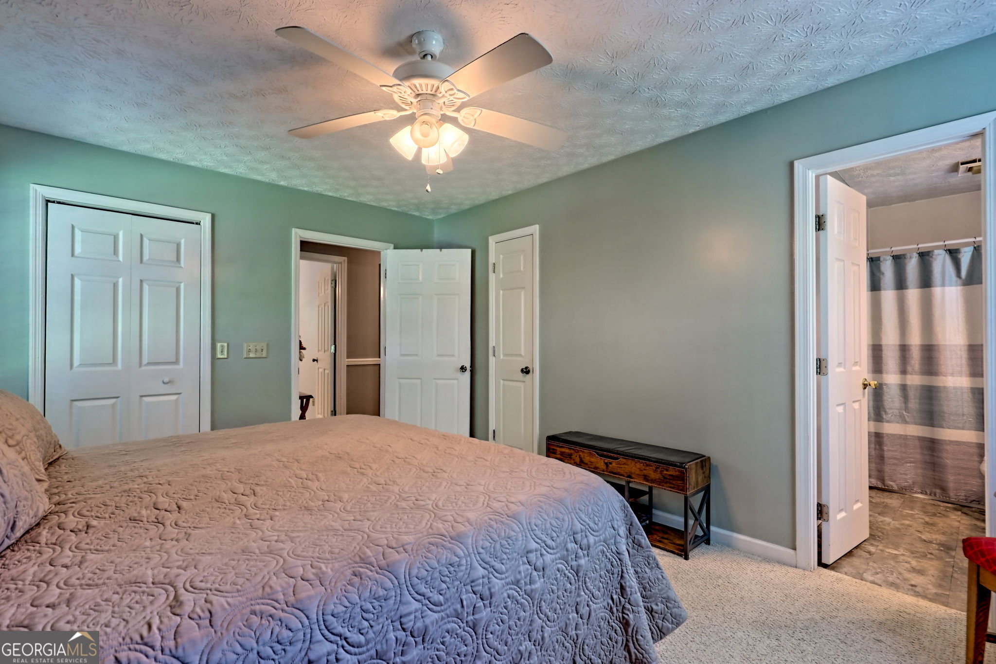 101 Long Street Demorest, GA 30535 - Photo 19 of 61 a bedroom with a large bed and a chandelier