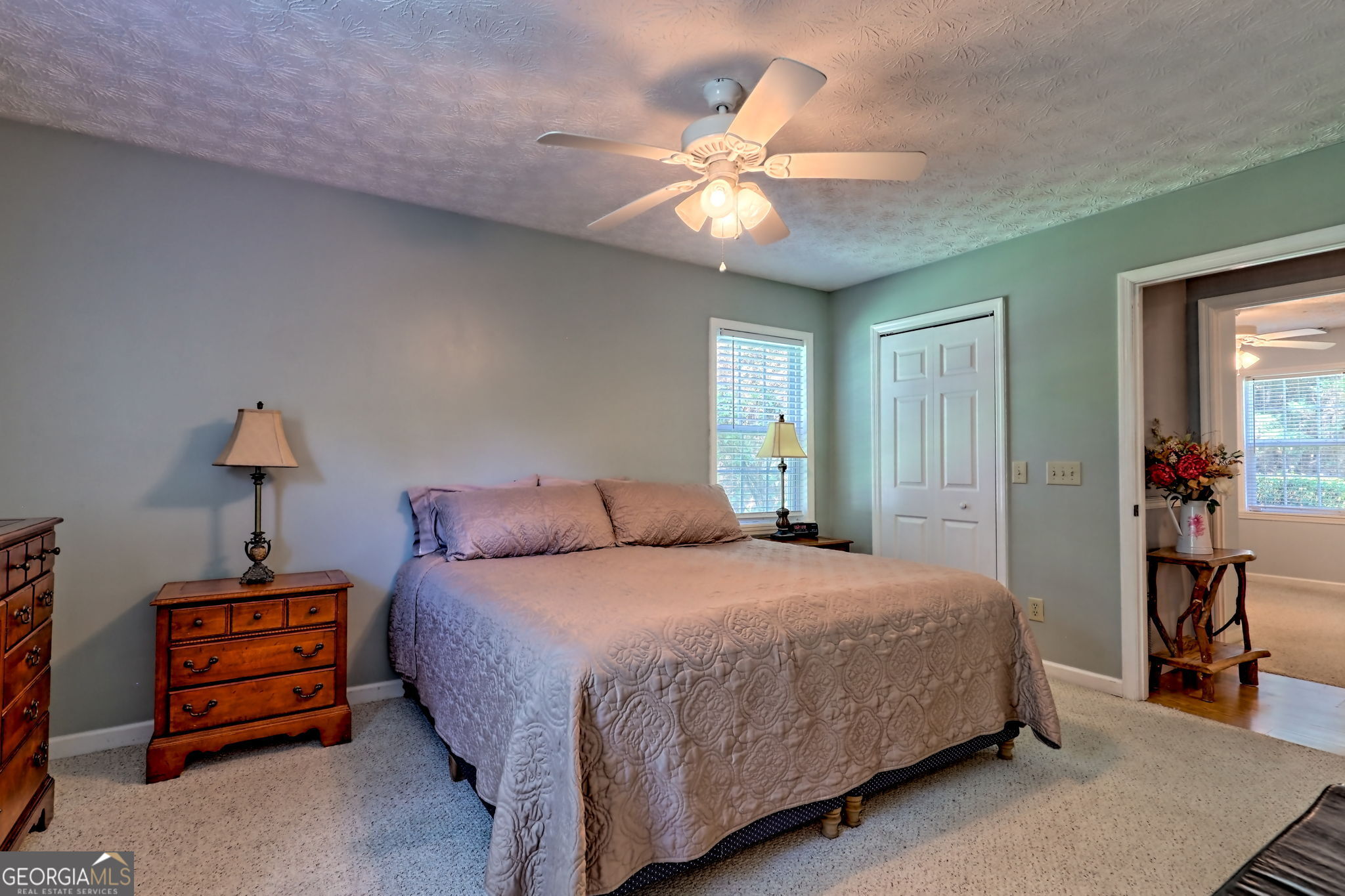 101 Long Street Demorest, GA 30535 - Photo 23 of 61 a bedroom with a bed and a chandelier
