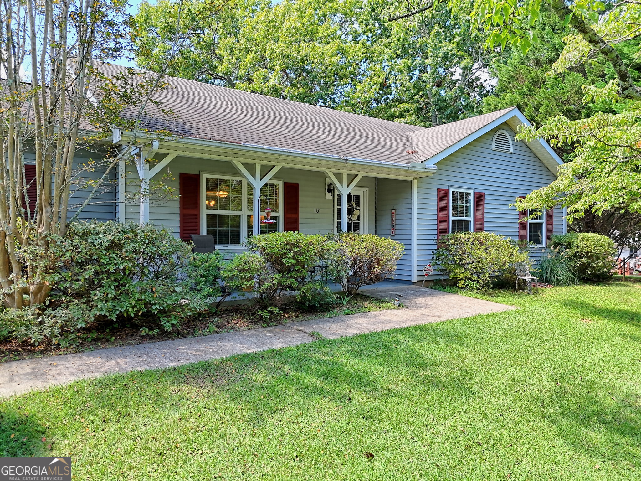 101 Long Street Demorest, GA 30535 - Photo 55 of 61 a view of a house with brick walls and a yard with plants and large trees
