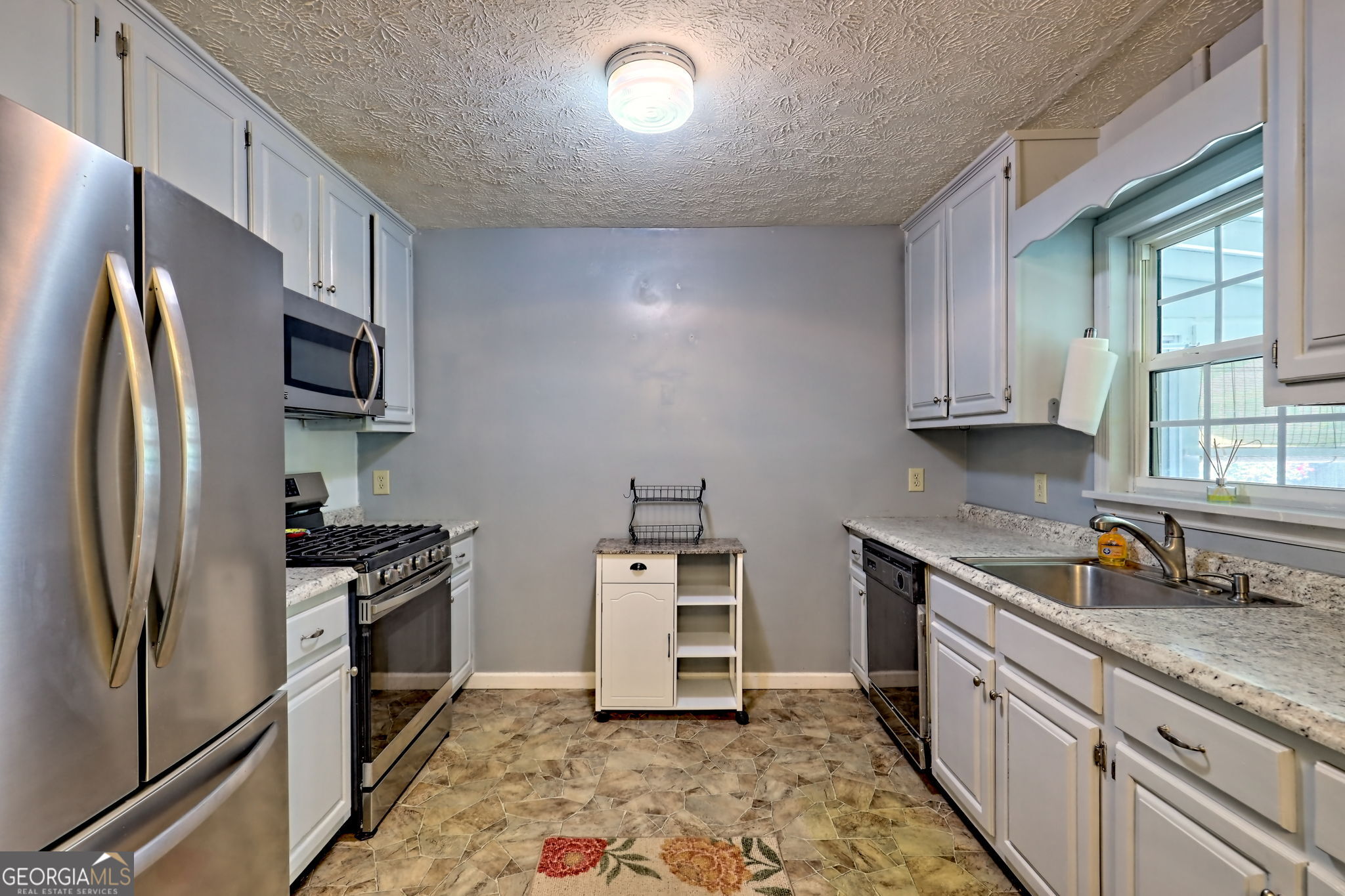 101 Long Street Demorest, GA 30535 - Photo 10 of 61 a kitchen with stainless steel appliances granite countertop a refrigerator stove and sink