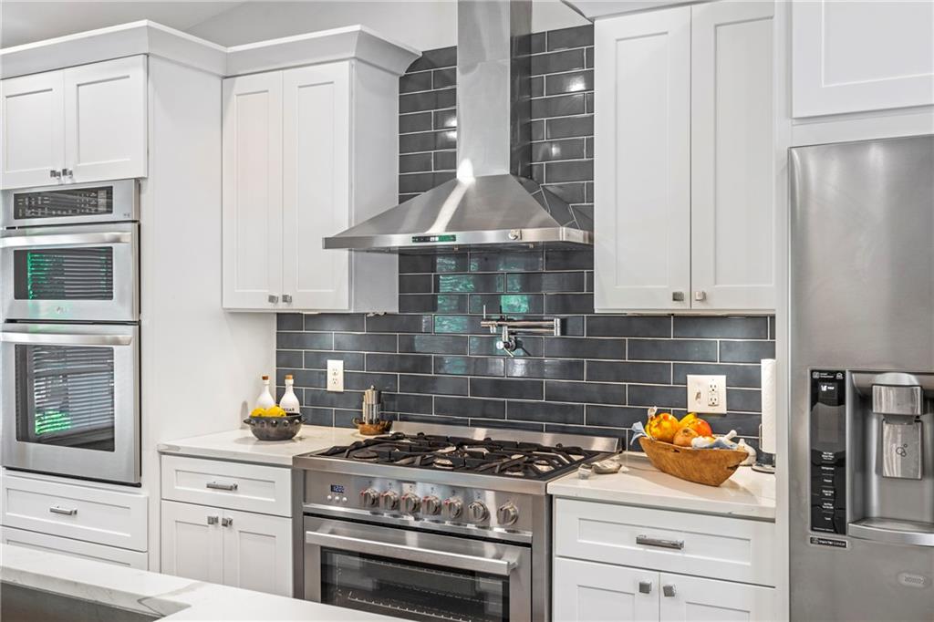 2632 Hawthorne Place Northeast Atlanta, GA 30345 - Photo 19 of 40 a kitchen with stainless steel appliances granite countertop a stove and a refrigerator