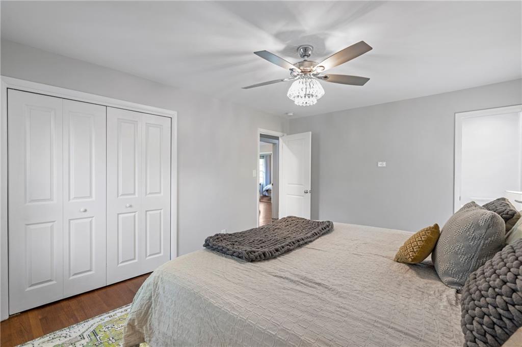 2632 Hawthorne Place Northeast Atlanta, GA 30345 - Photo 27 of 40 a bedroom with a large bed and a chandelier