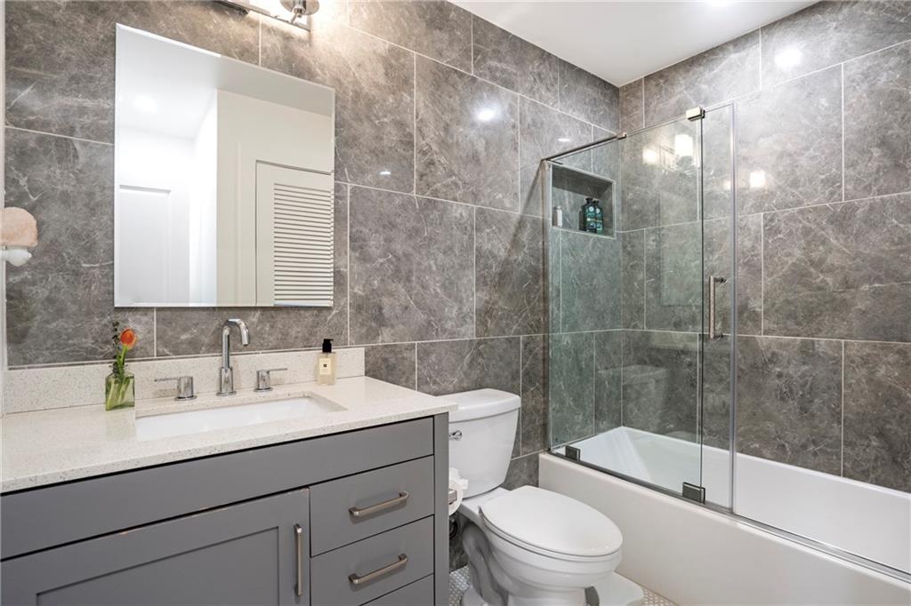 2632 Hawthorne Place Northeast Atlanta, GA 30345 - Photo 33 of 40 a bathroom with a sink a toilet and shower