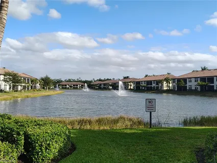 a view of a lake with houses in the back