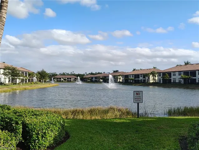 a view of a lake with houses in the back