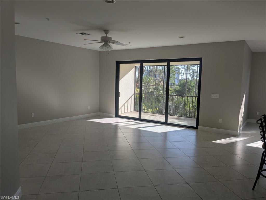 15188 Butler Lake Drive, Unit 202 Naples, FL 34109 - Photo 4 of 5 a view of an empty room with a window