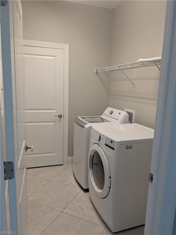 15188 Butler Lake Drive, Unit 202 Naples, FL 34109 - Photo 5 of 5 a utility room with dryer and washer