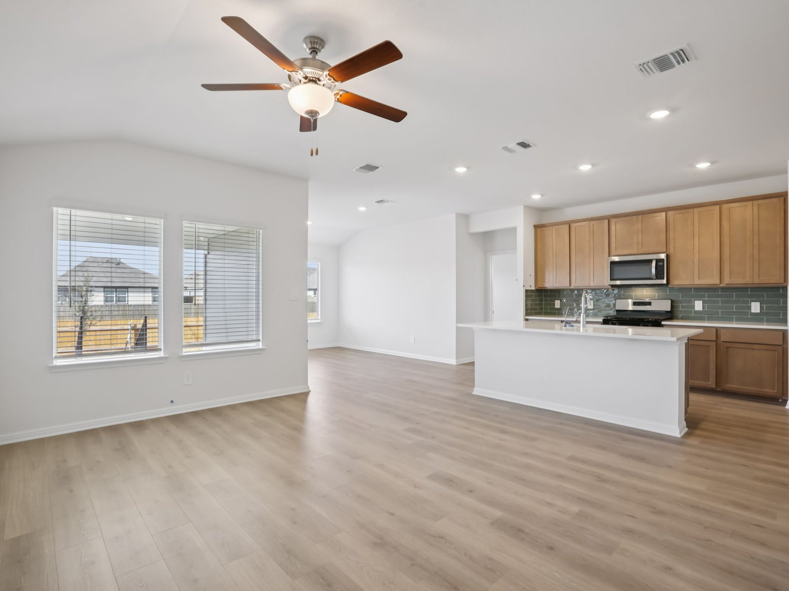 616 Timbo Drive Jarrell, TX 76537 - Photo 5 of 12 a view of kitchen with kitchen island wooden floor center island and stainless steel appliances