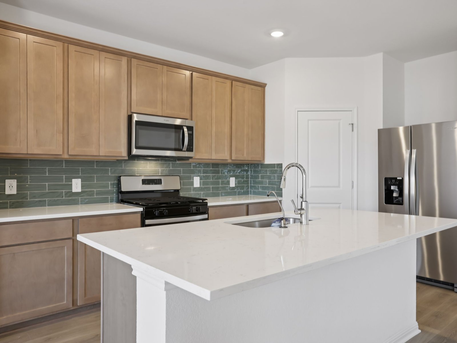616 Timbo Drive Jarrell, TX 76537 - Photo 6 of 12 a kitchen with stainless steel appliances a stove a sink a microwave and cabinets