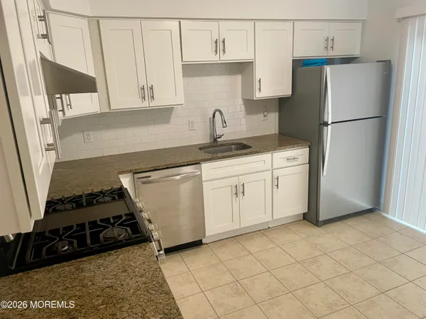 a kitchen with a stove and a refrigerator