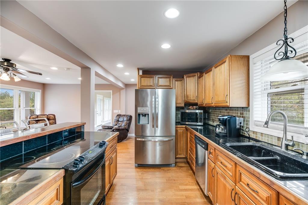 6792 Rockmart Road Southeast Silver Creek, GA 30173 - Photo 17 of 43 a kitchen with stainless steel appliances a sink stove and refrigerator
