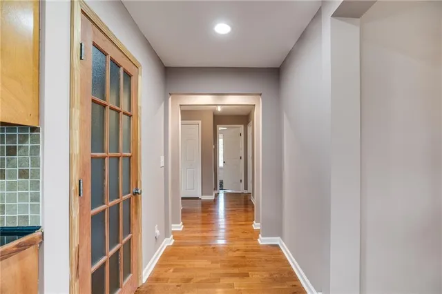 a view of hallway with wooden floor