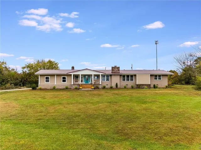 a front view of a house with a garden