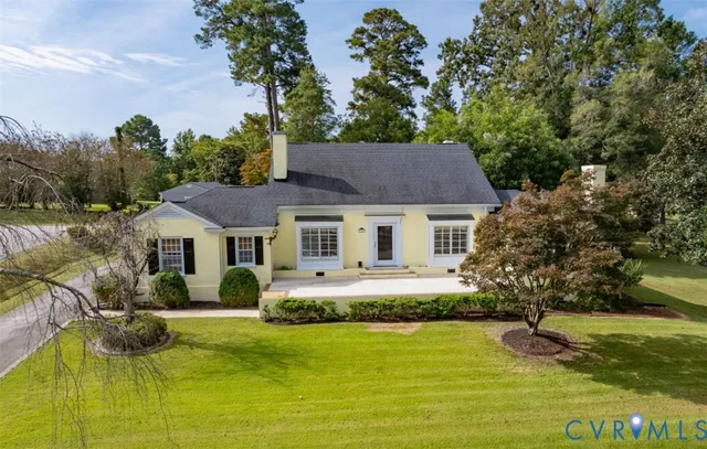 a front view of house with yard and trees