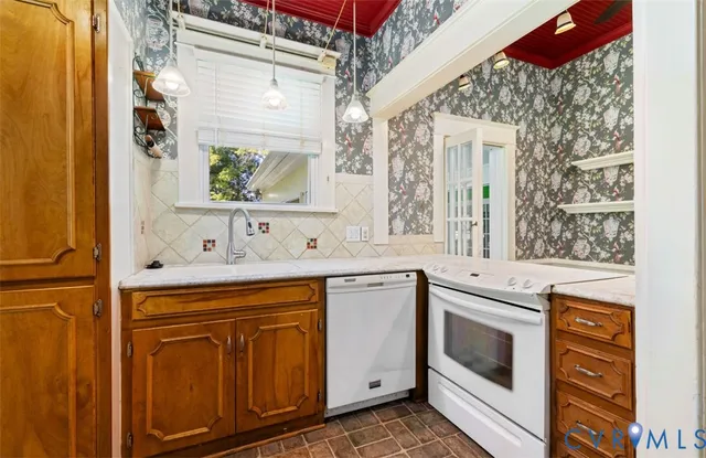 a view of a kitchen with a sink and dishwasher