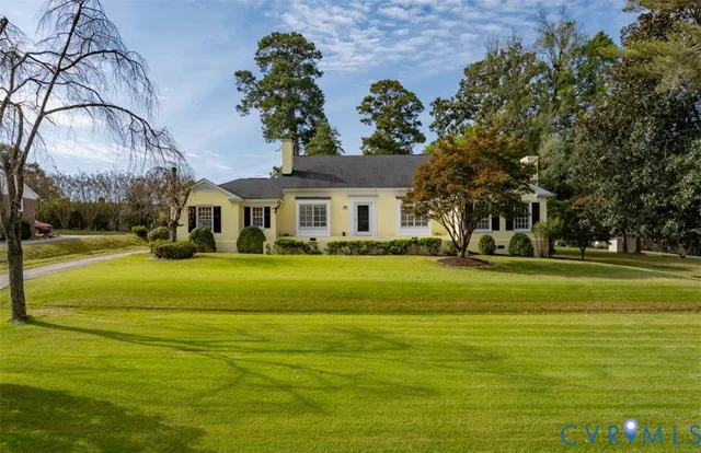 a front view of a house with a big yard