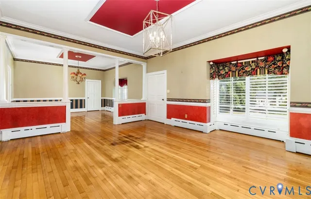a view of an empty room with a fireplace and a window