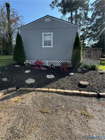 a front view of a building with a garden