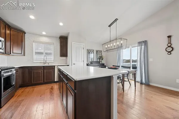 a kitchen with stainless steel appliances granite countertop a stove and cabinets
