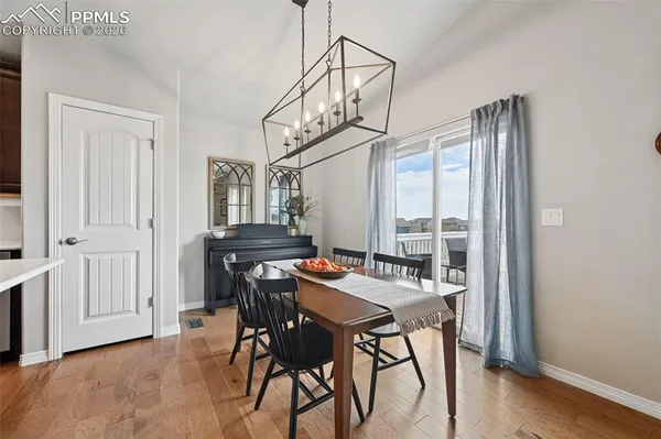 a view of a dining room with furniture window and wooden floor