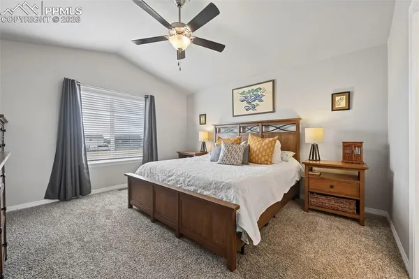 a spacious bedroom with a bed and a window