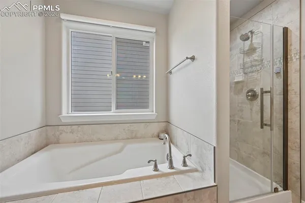 a bathroom with a bathtub and shower